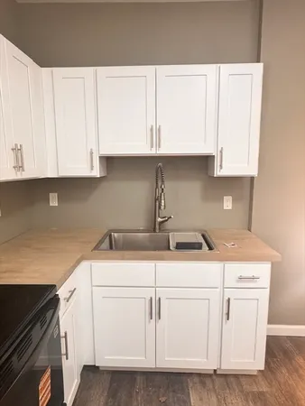 a kitchen with white cabinets and white appliances