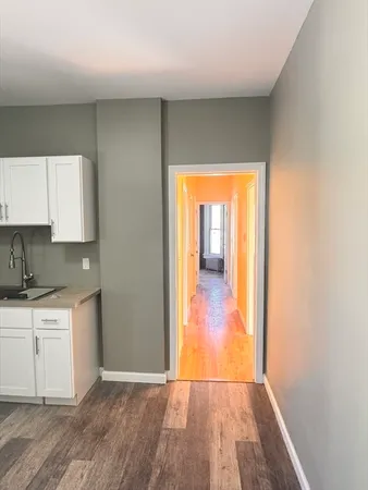 a view of a kitchen from a hallway