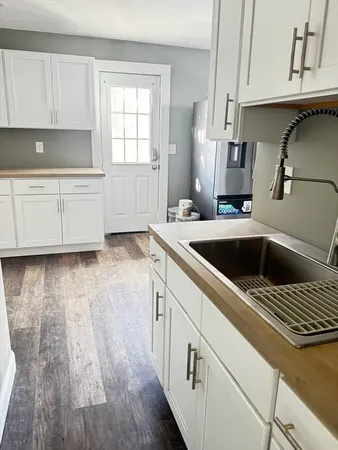 a kitchen with a sink a stove and cabinets