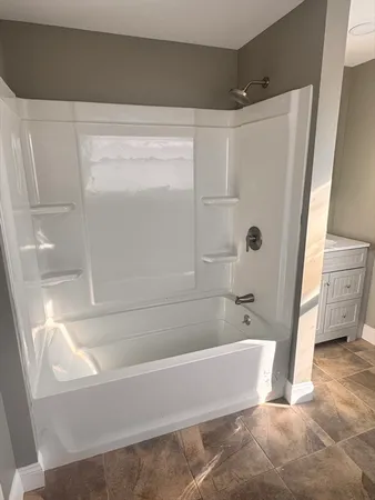 a bathroom with a bathtub and a shower