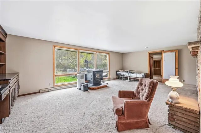a living room with furniture and a floor to ceiling window