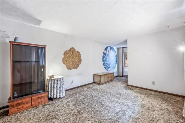 a view of room with window and wooden floor