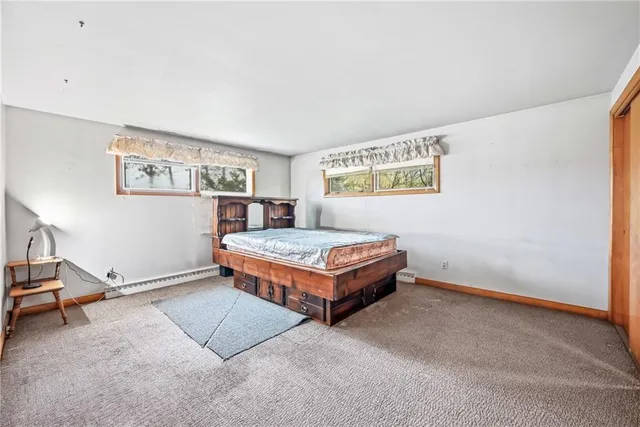 a living room with furniture and paintings on the wall