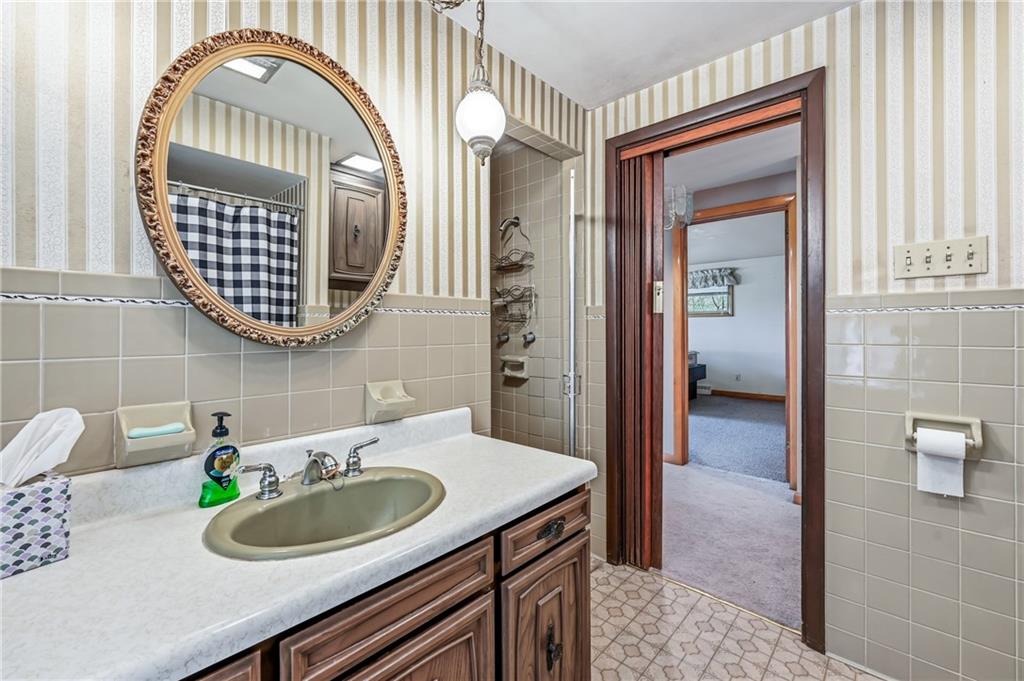 520 South Maysville Road Greenville, PA 16125 - Photo 23 of 33 a bathroom with a sink a mirror and a shower