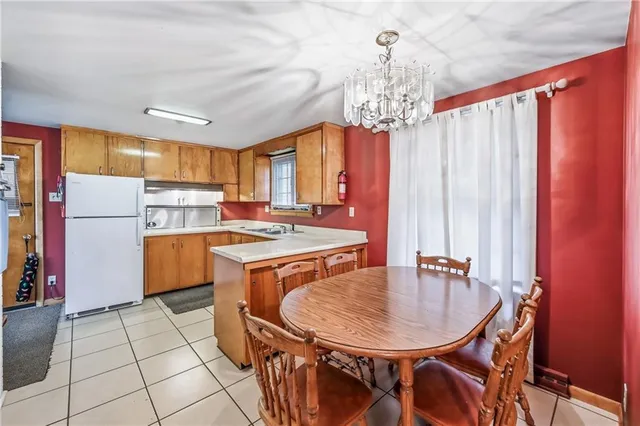 a kitchen with stainless steel appliances granite countertop a sink refrigerator and cabinets