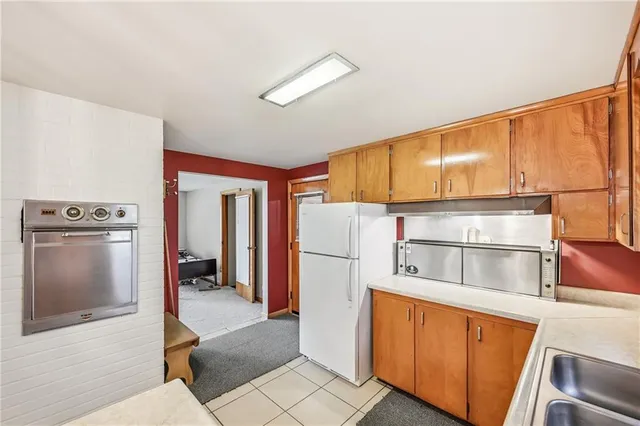 a kitchen with stainless steel appliances a refrigerator and a stove