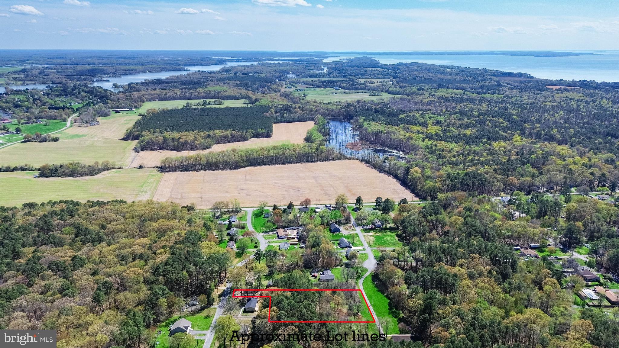 an aerial view of a house with a garden and lake view