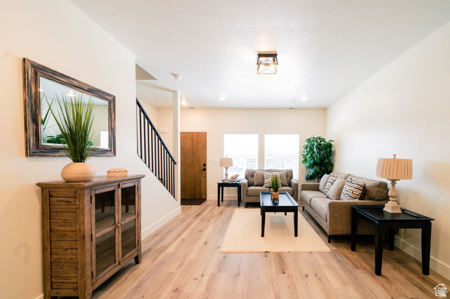 220 Spring Creek Parkway Providence, UT 84332 - Photo 4 of 17 Spacious living area featuring wood-finish flooring and ample natural light from two windows
