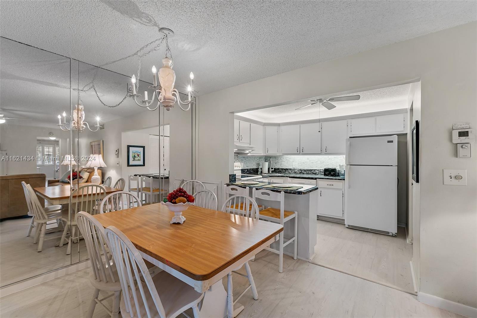 341 Pine Ridge Circle, Unit B2 Greenacres, FL 33463 - Photo 15 of 49 a kitchen with a table and chairs in it