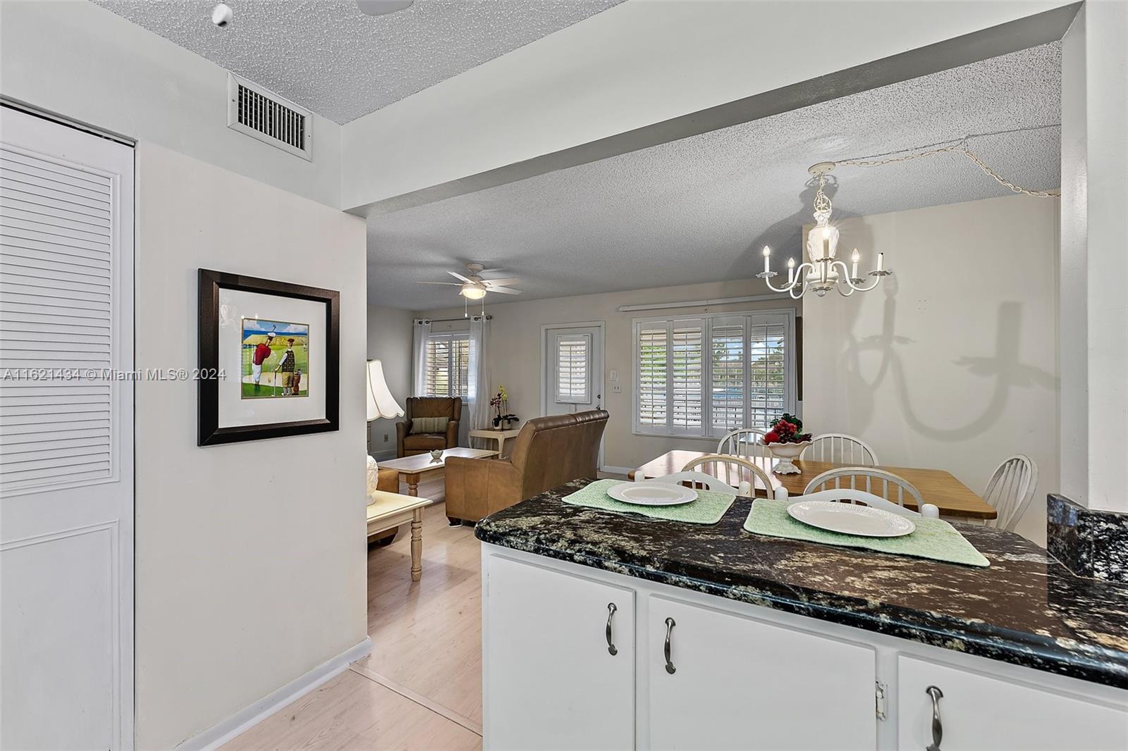 341 Pine Ridge Circle, Unit B2 Greenacres, FL 33463 - Photo 19 of 49 a living room with granite countertop furniture and fireplace