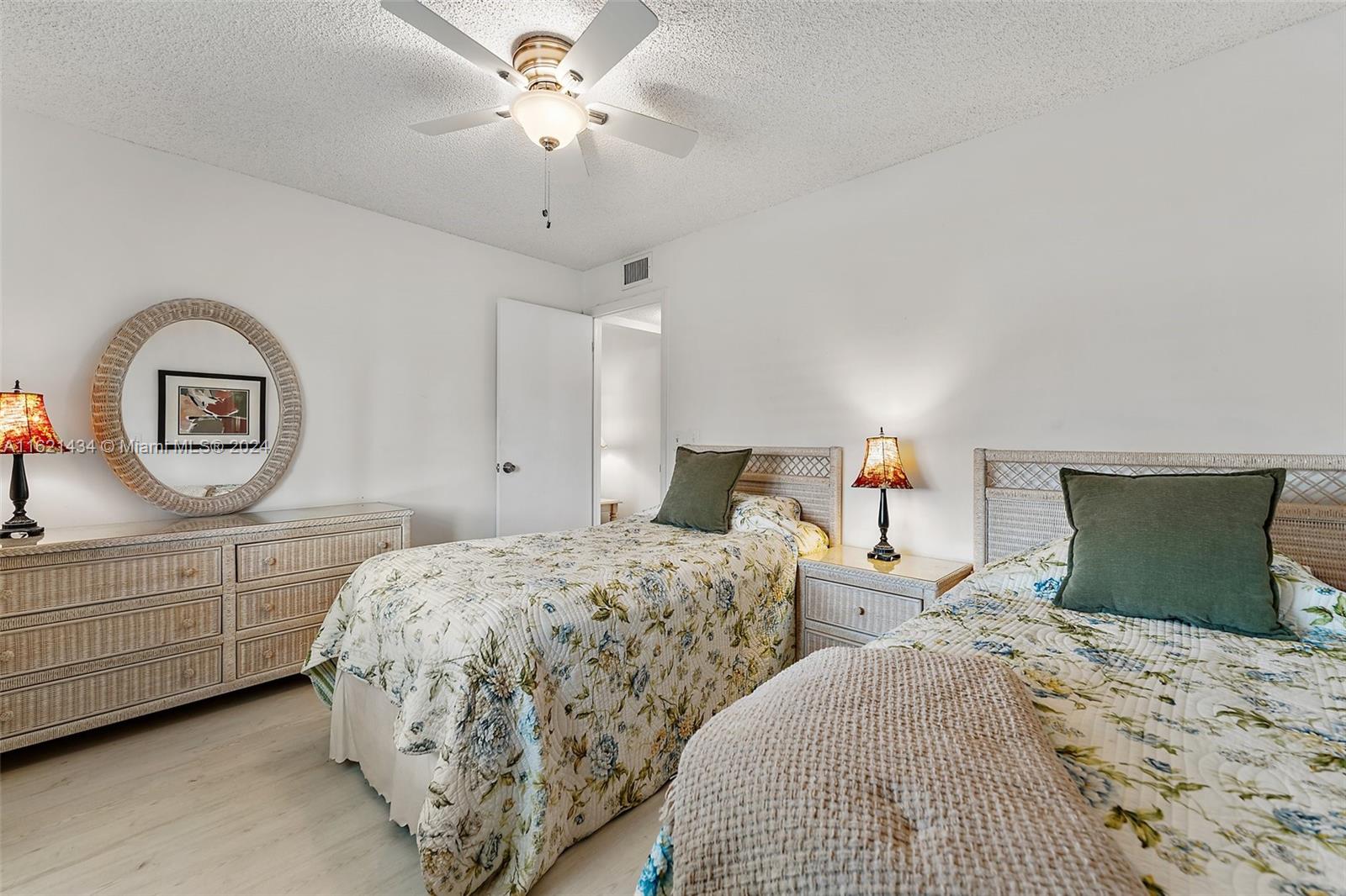 341 Pine Ridge Circle, Unit B2 Greenacres, FL 33463 - Photo 32 of 49 a bedroom with two bed and a dresser