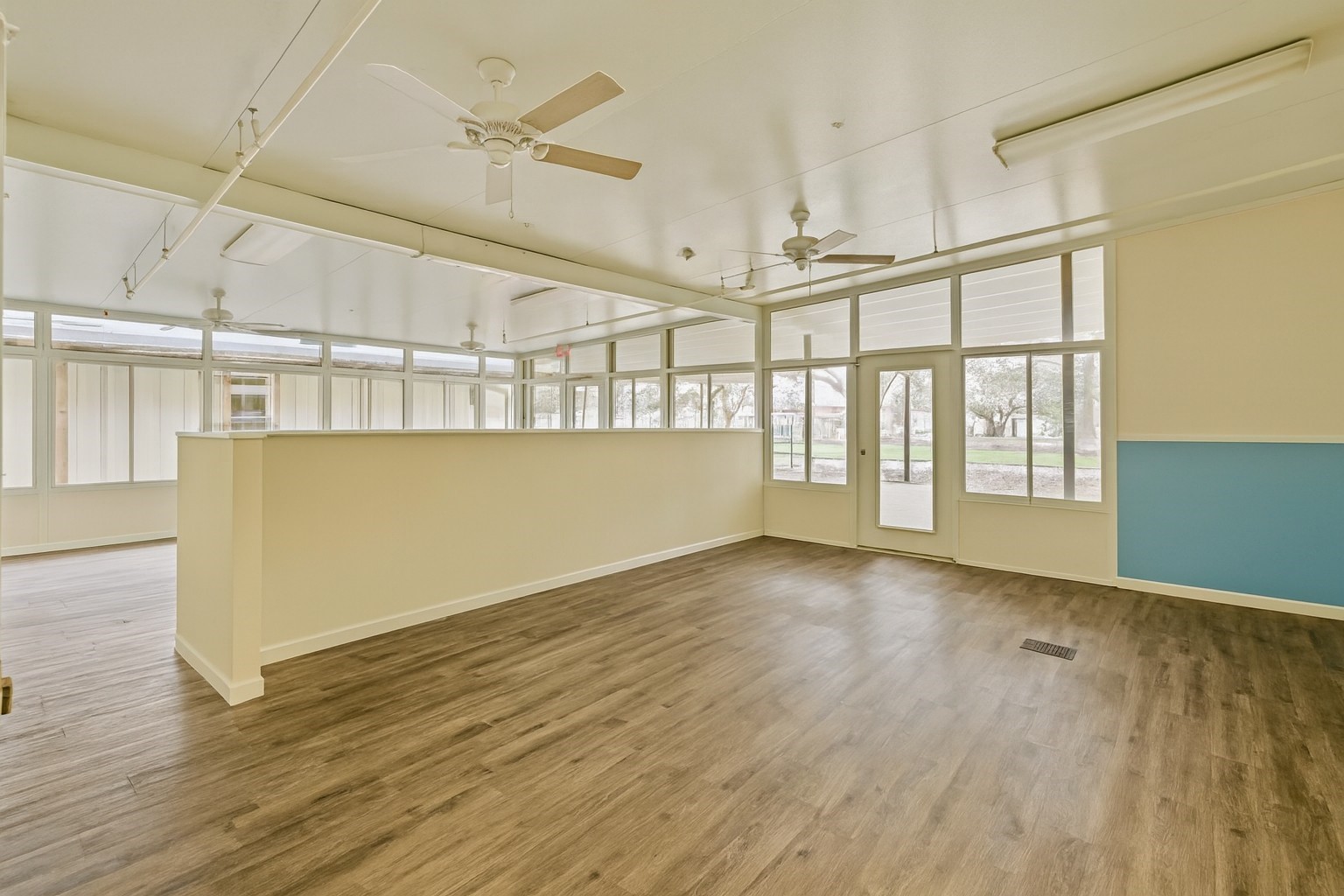 1030 4th Street Rosenberg, TX 77471 - Photo 15 of 39 an empty room with wooden floor and windows