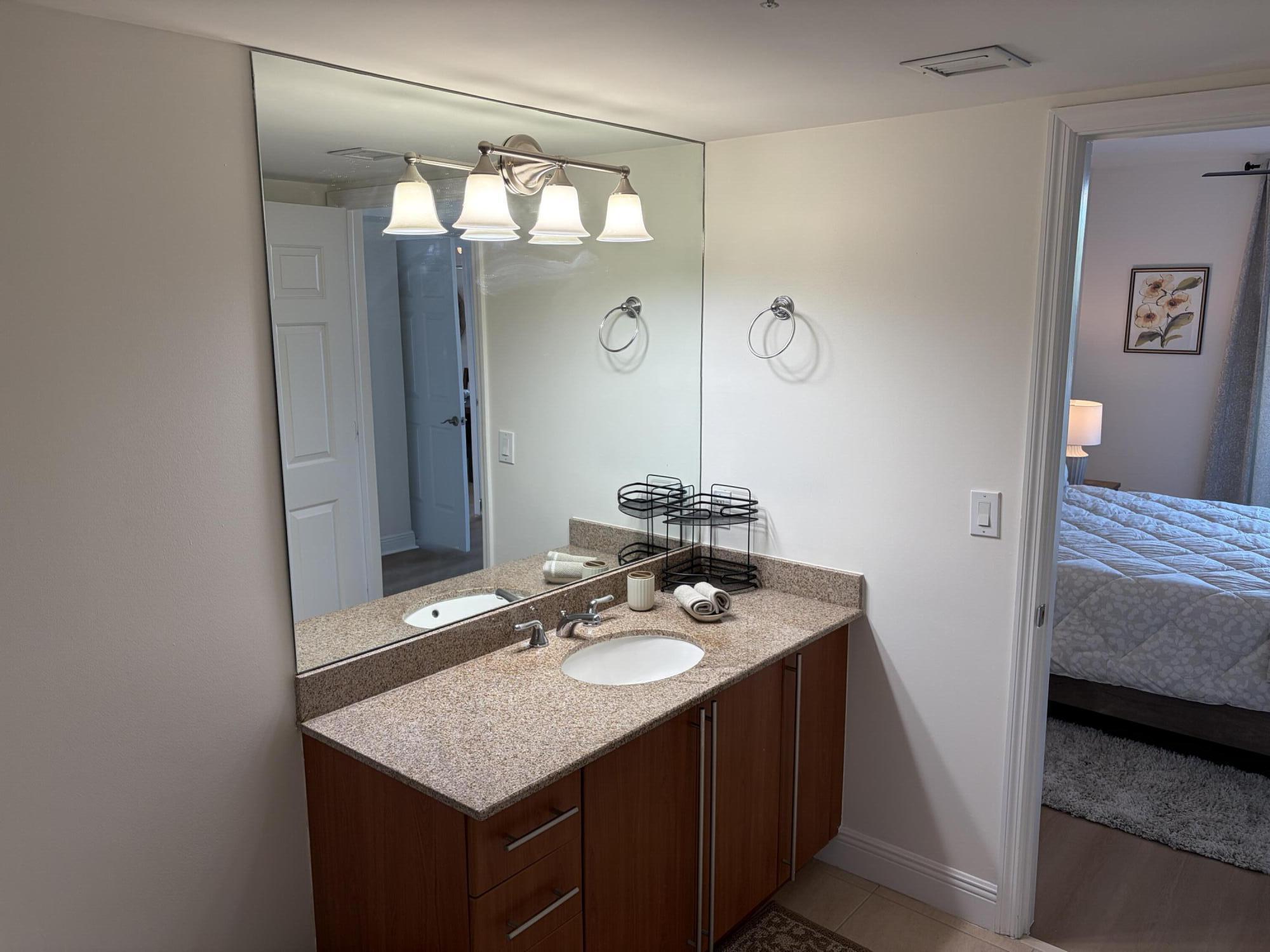 610 Clematis Street West Palm Beach, FL 33401 - Photo 17 of 33 a bathroom with a sink vanity and a mirror