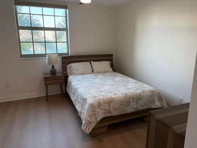 a bedroom with a bed and a dresser