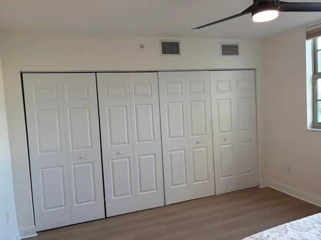 a view of walk in closet with empty racks