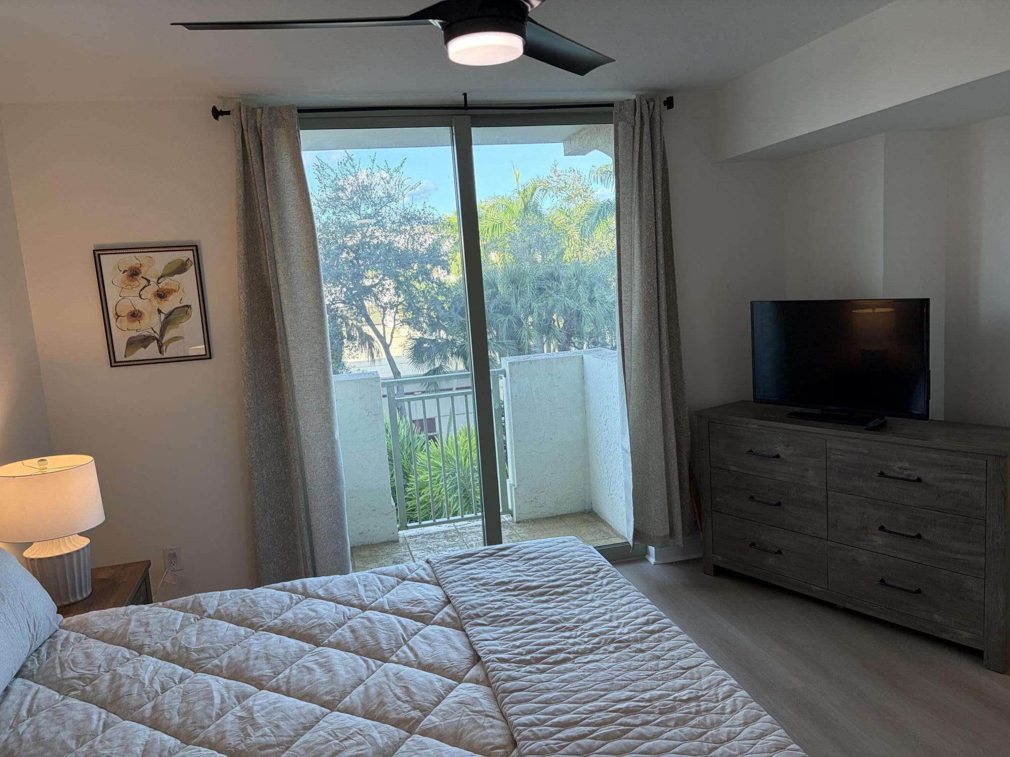 610 Clematis Street West Palm Beach, FL 33401 - Photo 31 of 33 a bedroom with a bed and a flat screen tv
