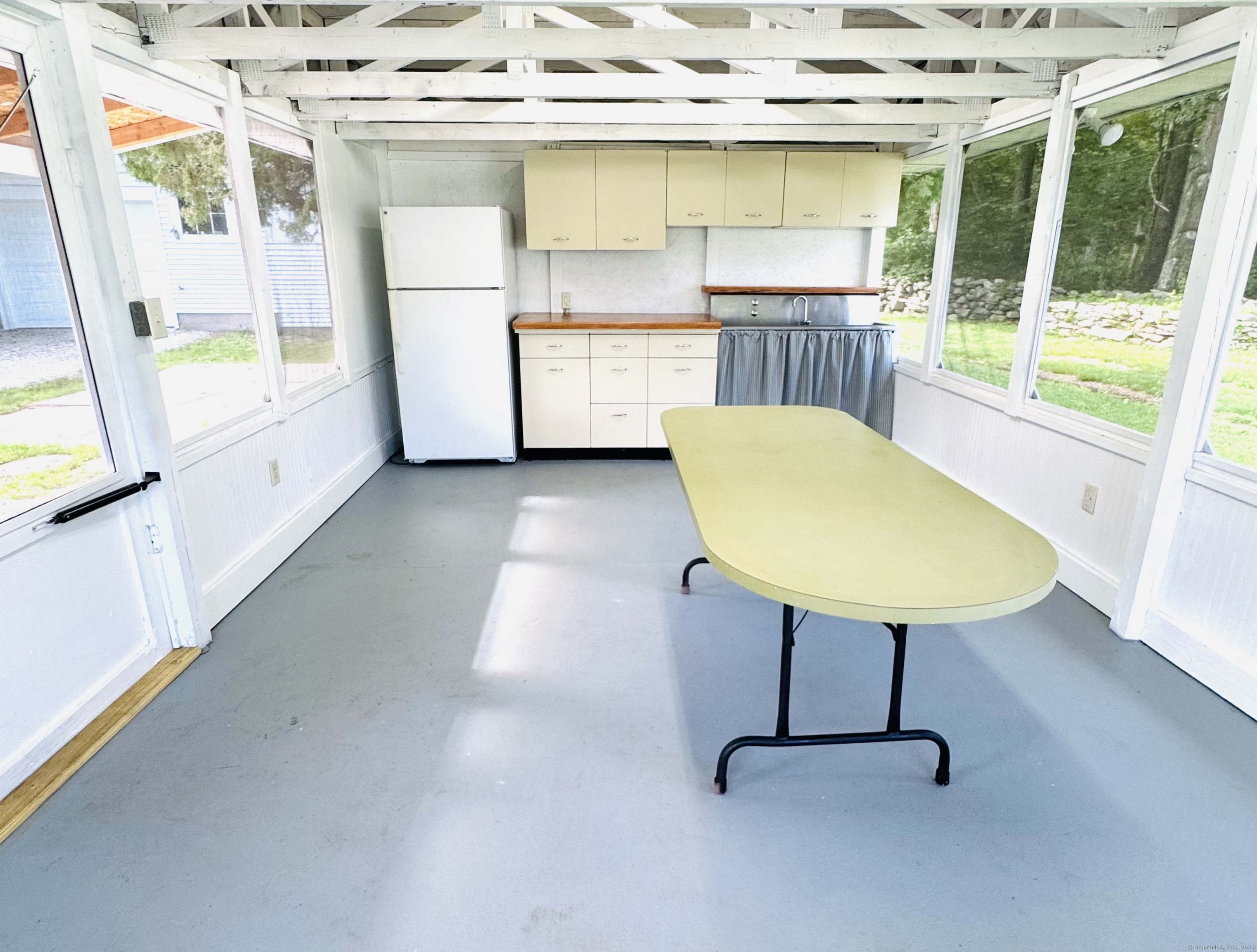 361 Westminster Road Canterbury, CT 06331 - Photo 27 of 38 a view of a kitchen with a sink and wooden cabinets