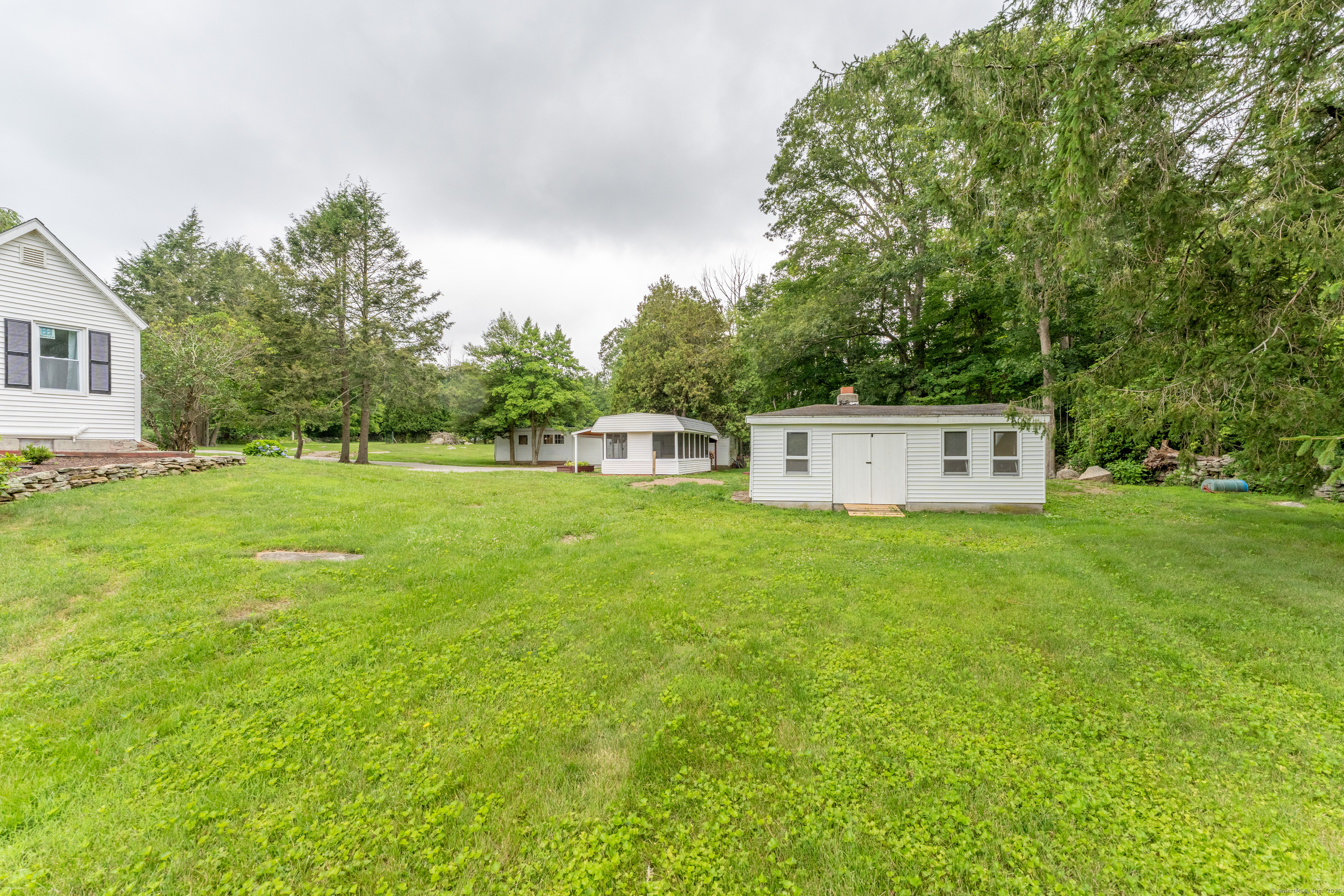361 Westminster Road Canterbury, CT 06331 - Photo 33 of 38 a view of a house with a yard and a tree