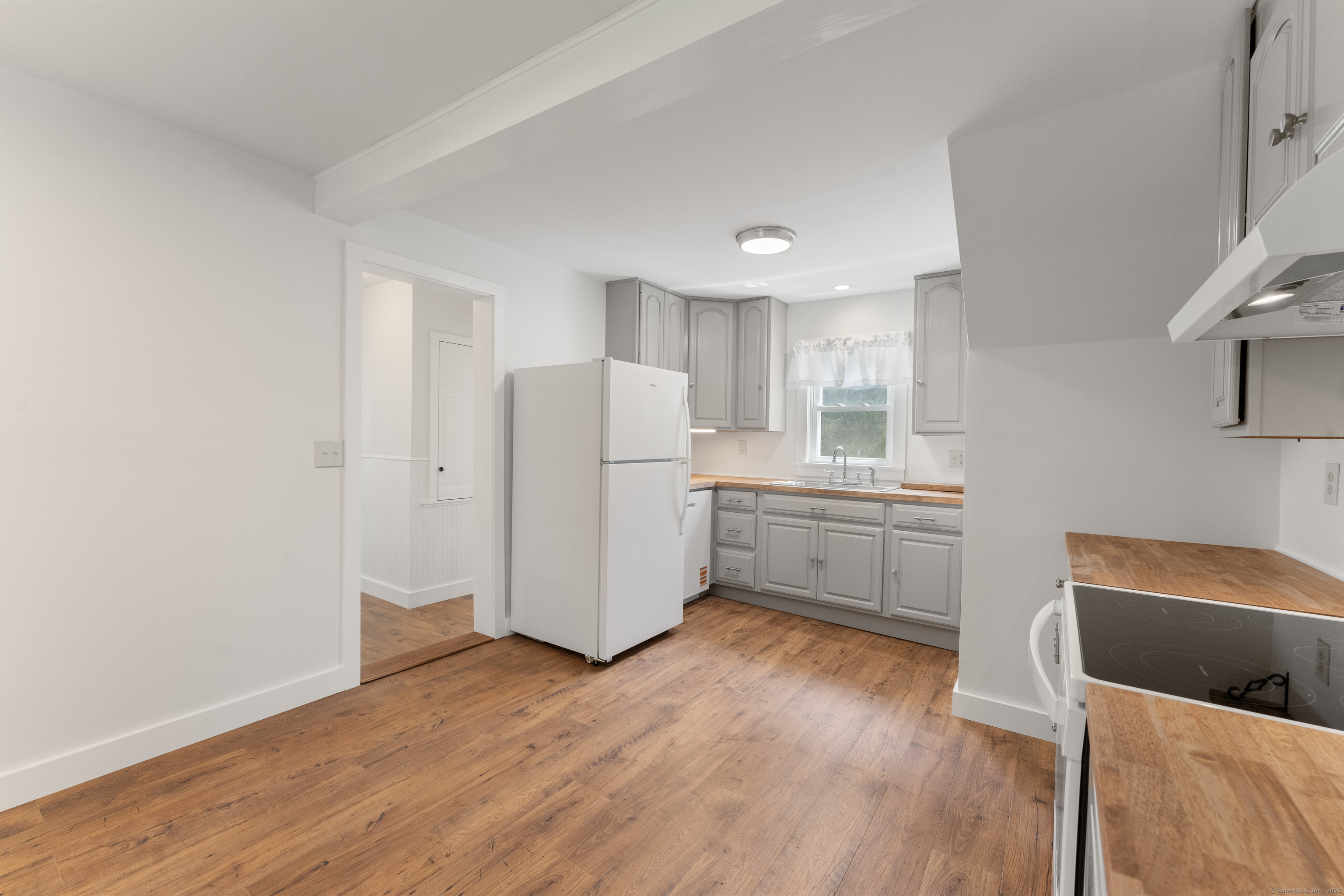 361 Westminster Road Canterbury, CT 06331 - Photo 8 of 38 a kitchen with stainless steel appliances a refrigerator and wooden floor