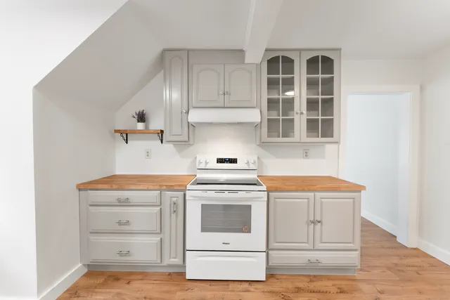 a kitchen with a stove and cabinets