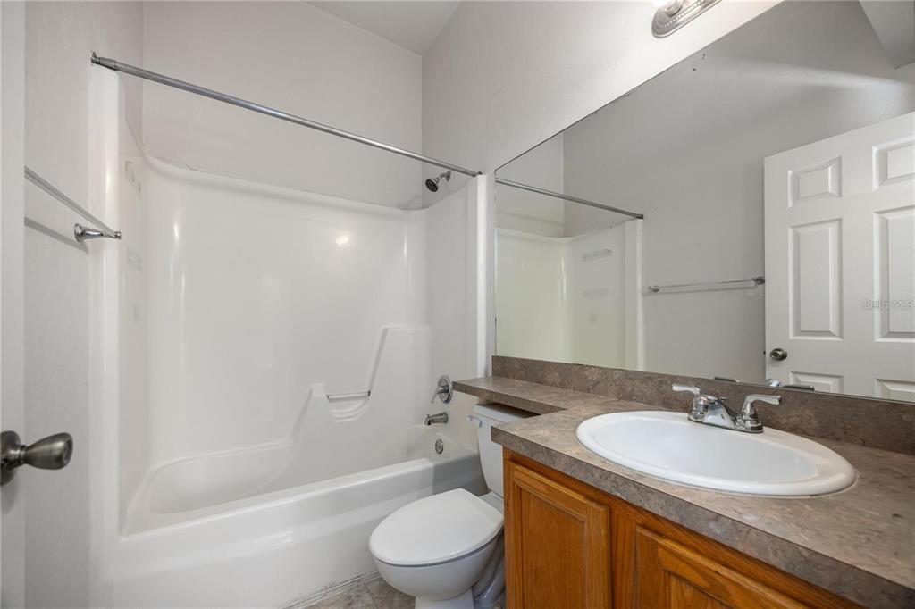 3510 Southwest 30th Way, Unit 158 Gainesville, FL 32608 - Photo 26 of 27 a bathroom with a sink a toilet and shower