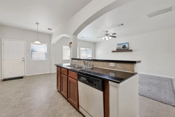 a kitchen with a sink and a stove top oven