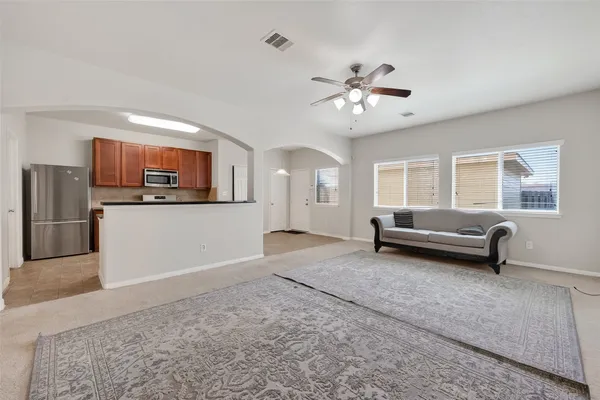 a view of a livingroom with furniture and a ceiling fan