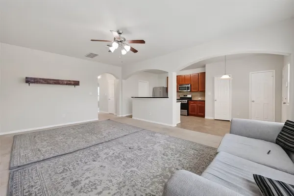 a view of a livingroom with furniture and a ceiling fan