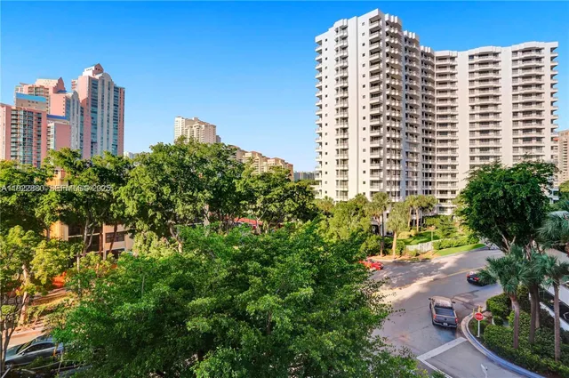 a view of a lake with boats and trees in the background