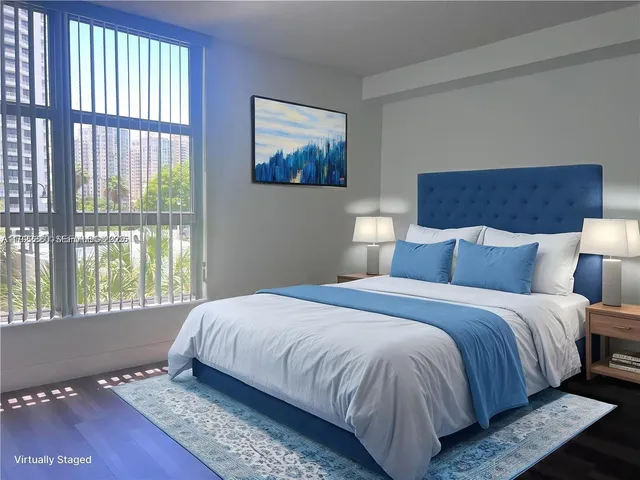 a bedroom with a bed and glass window