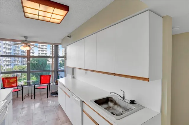 a white kitchen with a stove and white cabinets