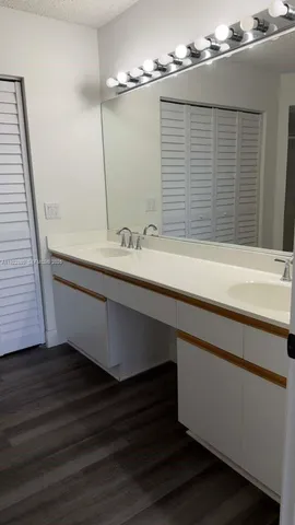 a view of a big room with wooden floor and windows