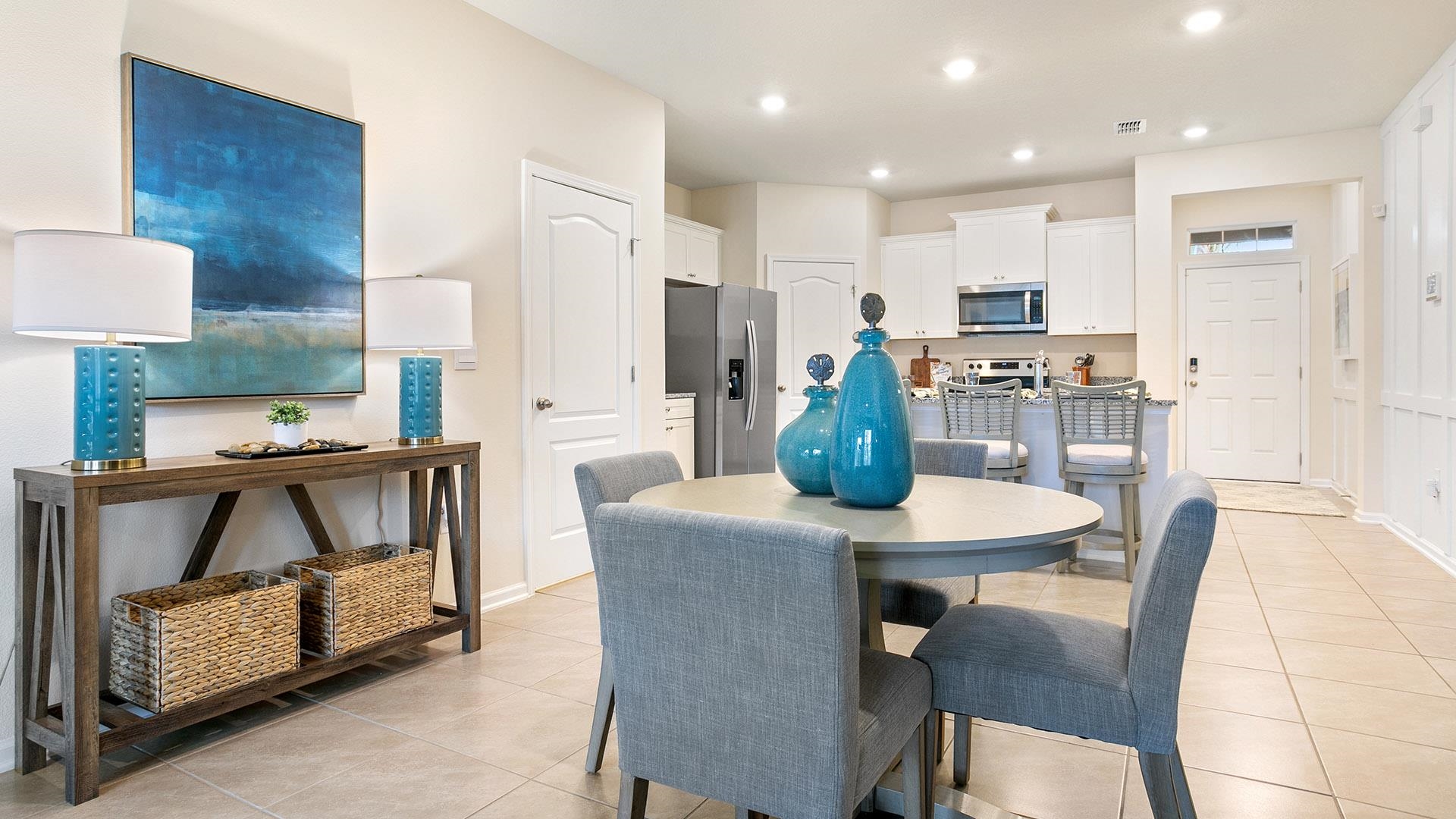 237 Redbud Road Palm Coast, FL 32137 - Photo 9 of 33 a kitchen with a table chairs and a refrigerator