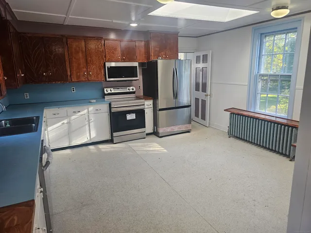 a kitchen with a refrigerator sink and microwave