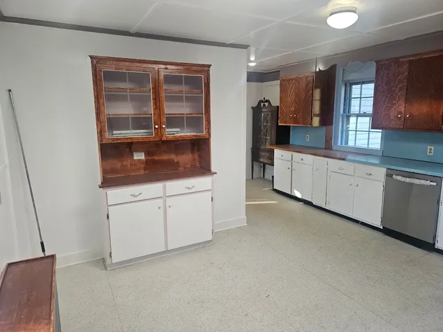 a kitchen with white cabinets and white appliances