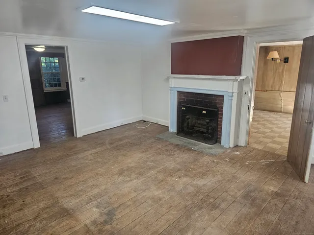 a view of an empty room with a fireplace