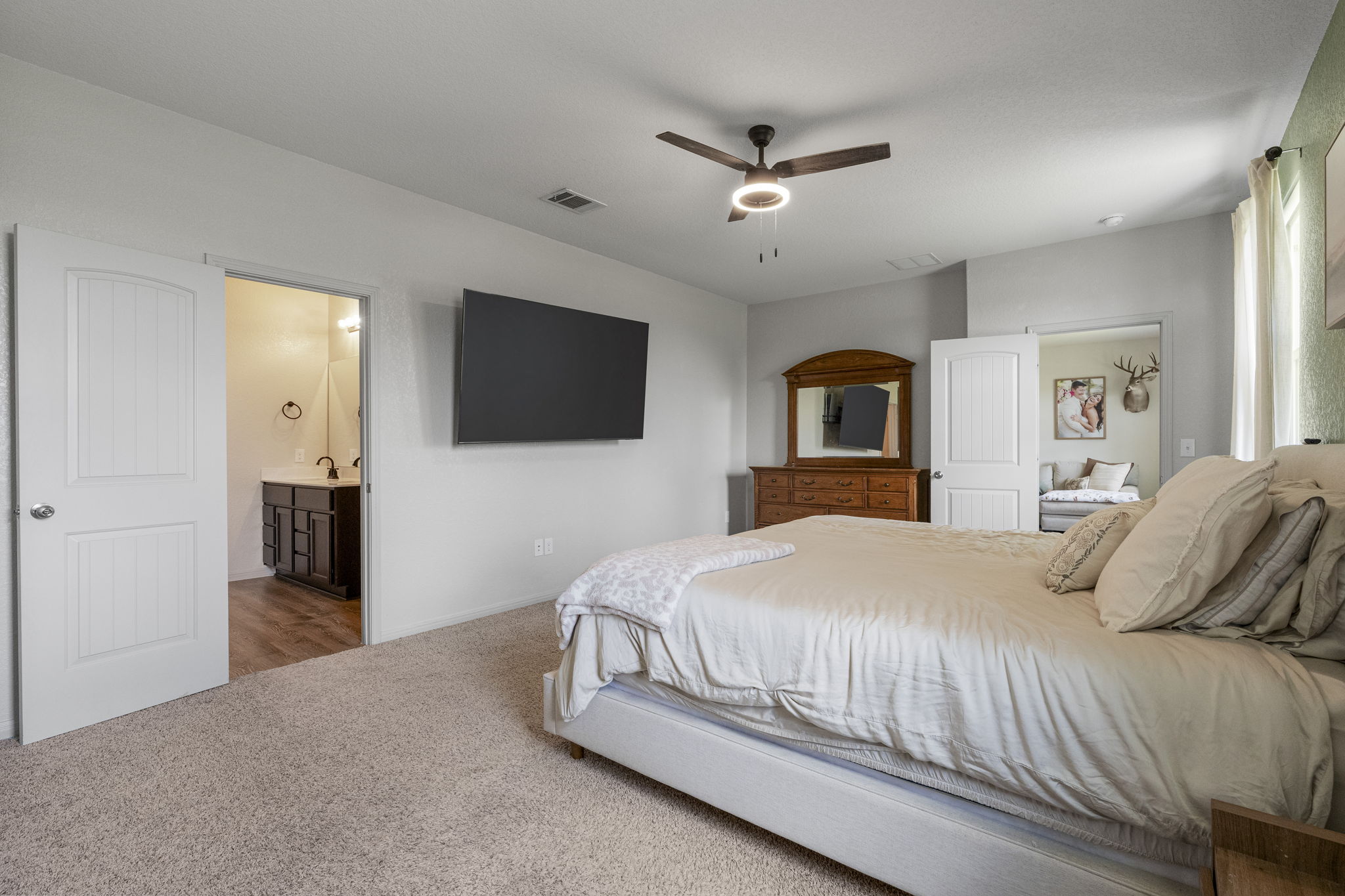 185 Struss Drive Georgetown, TX 78626 - Photo 13 of 23 Plush carpeting and a classic ceiling fan elevate this restful bedroom retreat.