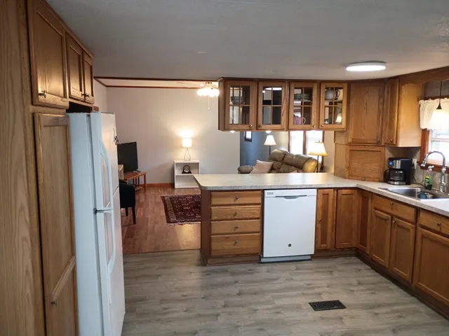 a kitchen with a refrigerator sink and cabinets