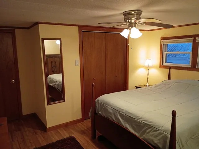 a bedroom with a bed and a chandelier