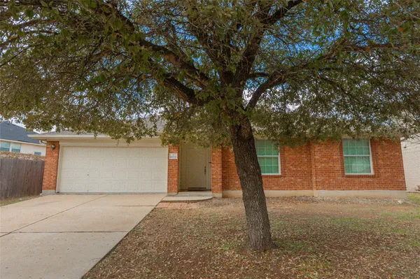 a front view of house with yard and trees