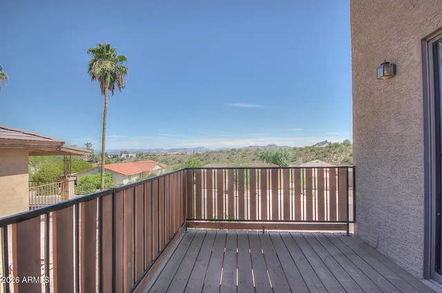 a view of a balcony with wooden floor