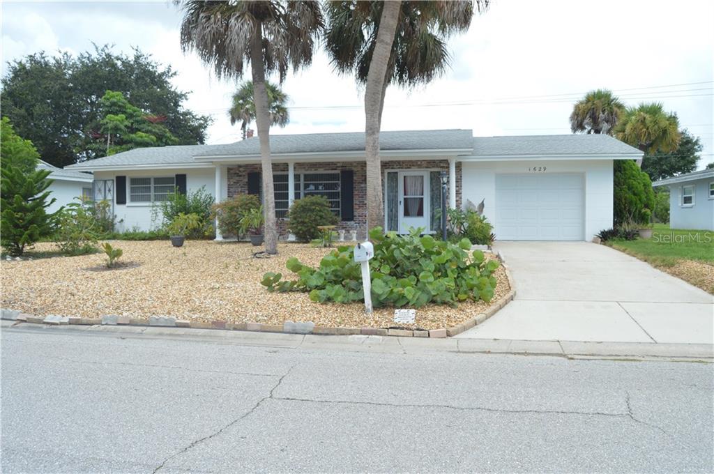 1629 Alton Road Venice, FL 34293 - Photo 1 of 1 front view of a house with a garden