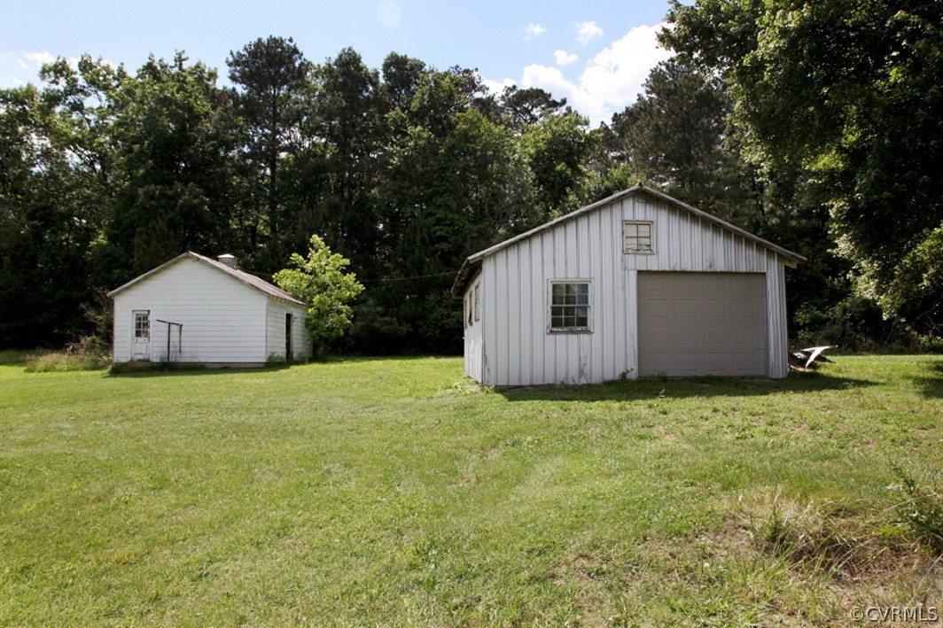 7290 Strath Road Henrico, VA 23231 - Photo 4 of 18 a front view of house with garden and trees