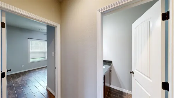 a view of a hallway with wooden floor and staircase