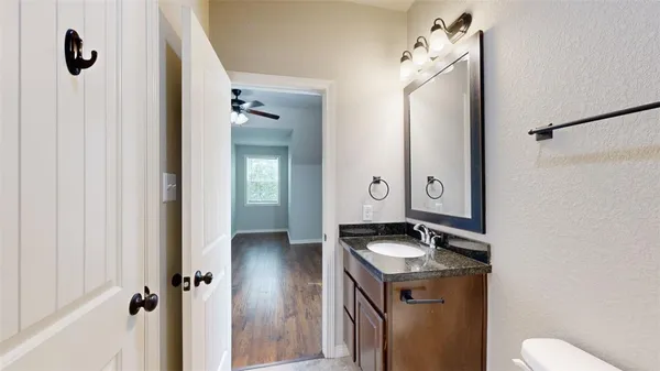 a bathroom with a granite countertop sink toilet and shower