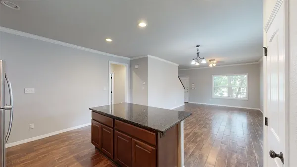 a view of kitchen and hallway with wooden floor