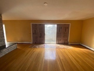 118 Kendall Road Lexington, MA 02421 - Photo 16 of 33 an empty room with wooden floor and windows