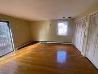 118 Kendall Road Lexington, MA 02421 - Photo 19 of 33 an empty room with wooden floor and windows