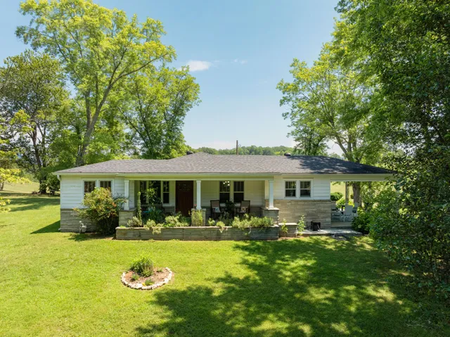 a front view of house with yard and green space
