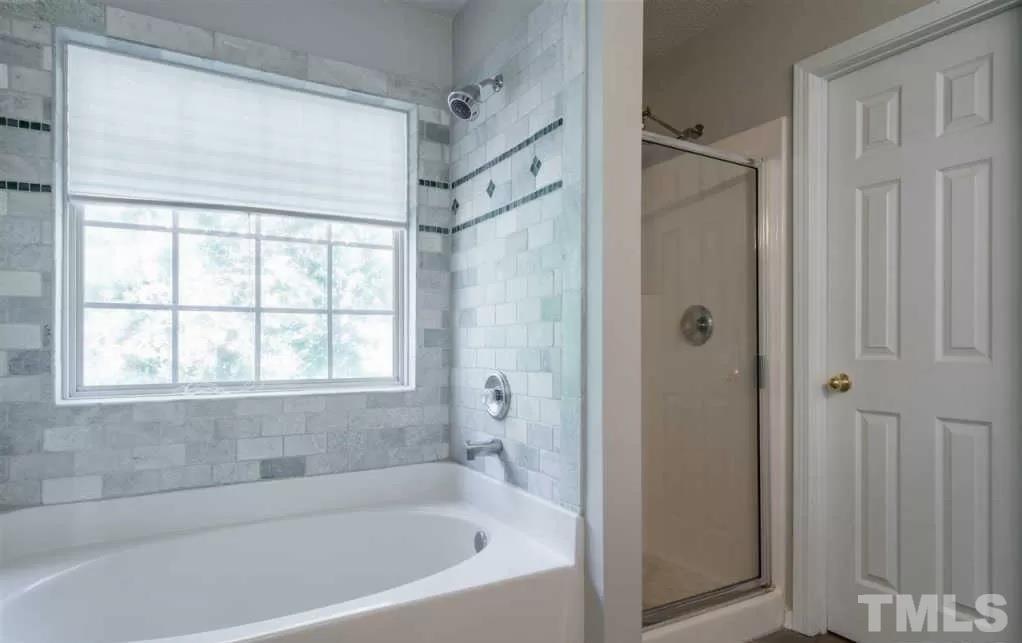 302 Durston Loop Morrisville, NC 27560 - Photo 3 of 4 a white bath tub sitting next to a shower